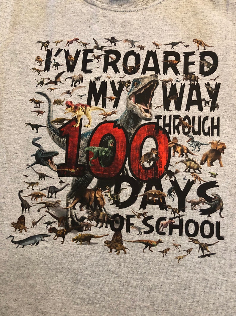 100th Day of School T Shirt 100 dinosaurs I've roared my way through 100 days of school Ships very quickly Now in gray, white, sand,red Athletic Heather