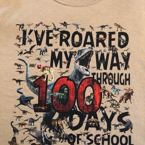100th Day of School T Shirt 100 dinosaurs I've roared my way through 100 days of school Ships very quickly Now in gray, white, sand,red Sand NOinfant / todd