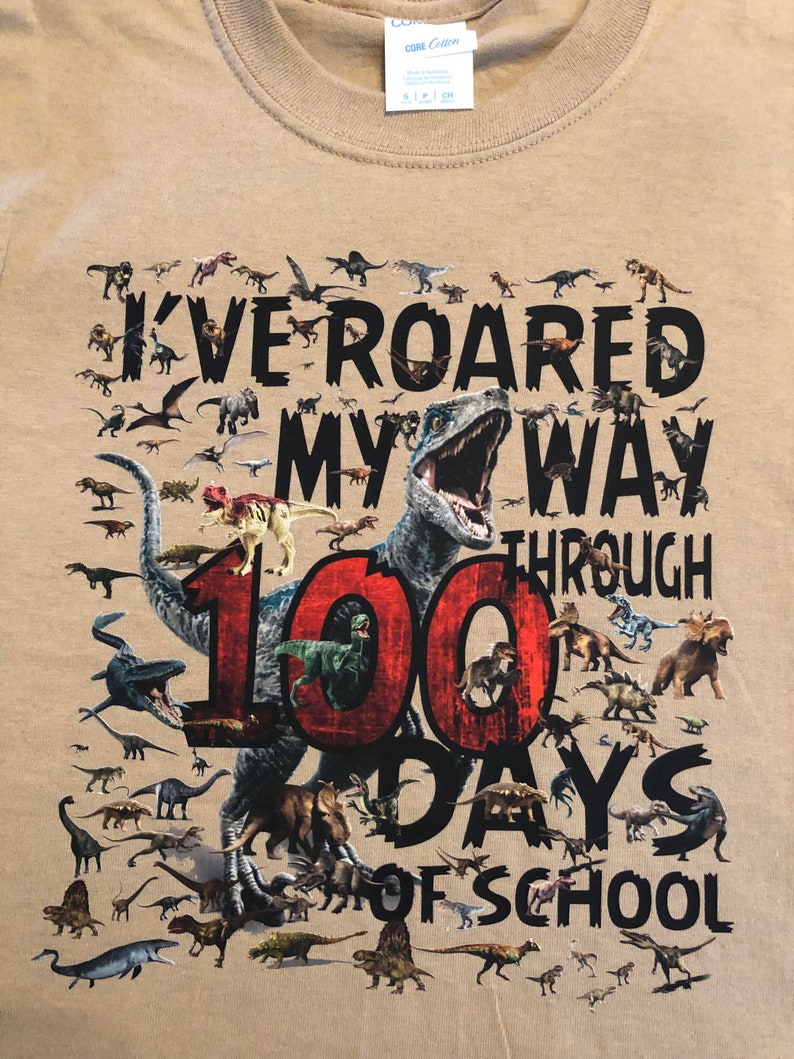 100th Day of School T Shirt 100 dinosaurs I've roared my way through 100 days of school Ships very quickly Now in gray, white, sand,red Sand NOinfant / todd
