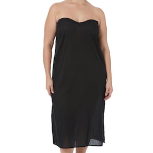 May include: A black strapless dress with a sweetheart neckline. The dress is knee-length and has a simple, elegant design. The model is standing barefoot on a white background.