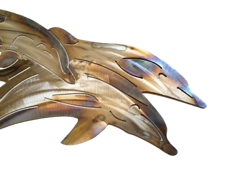 May include: Two metal dolphins leaping out of the water, with a brushed metal finish and iridescent highlights.