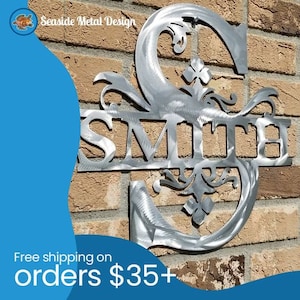 May include: A metal sign with the last name "SMITH" in a decorative font. The letters are attached to a metal S with a floral design. The sign is mounted on a brick wall.