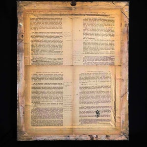 May include: A rectangular framed display featuring four pages of vintage Italian legal text arranged in a grid. The paper is aged with a yellowed, sepia-toned patina, showing visible creases and handwritten annotations in the margins of the printed columns.