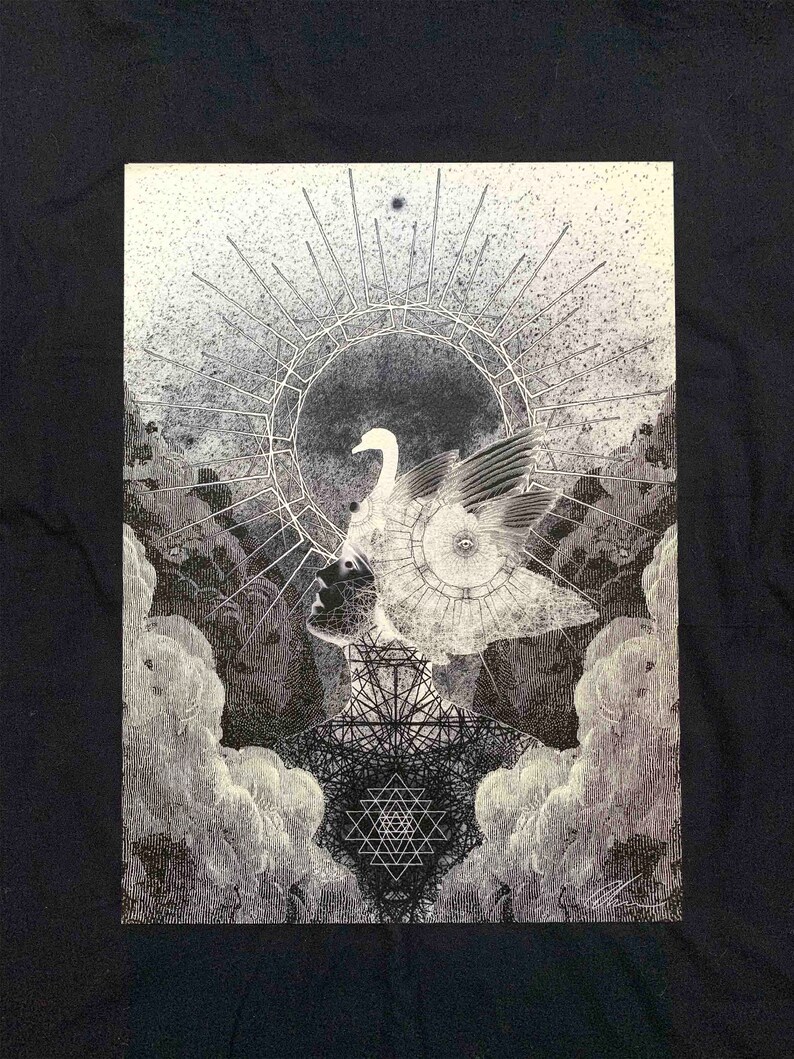 May include: A black t-shirt featuring a detailed white ink illustration of a profile silhouette with a swan headpiece, a radiant sunburst halo, geometric patterns, and a central Sri Yantra symbol, all surrounded by textured clouds and stippling.
