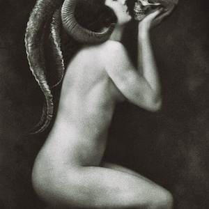 May include: A black and white artistic print depicting a kneeling figure with large, curved ram horns extending from the head. The figure is shown in profile, holding a human skull near the face in a gesture of close proximity against a dark background.