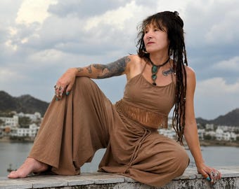 May include: A brown two-piece set consisting of a sleeveless crop top with a fringed hem and wide-leg trousers with a drawstring waist. The top features thin spaghetti straps and a straight neckline, while the trousers have a loose, flowing fit.