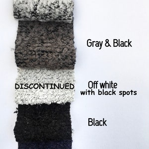 May include: Five fabric swatches in different colors and patterns. The swatches are labeled "White & Black", "Gray & Black", "Off white with black spots", "Black", and "Navy Blue". The swatch labeled "Off white with black spots" is marked "DISCONTINUED".