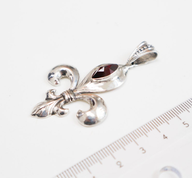 Fleur-de-lis pendantsterling silver with garnet