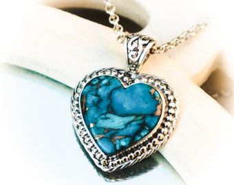 A beautiful turquoise heart in a sterling silver fantasy setting