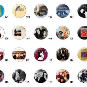 May include: A collection of 20 round button pins featuring album covers from various 80s music artists. The pins are arranged in a grid of four rows and five columns. The artists featured include Duran Duran, Tears for Fears, OMD, Orchestral Manoeuvres in the Dark, and more.