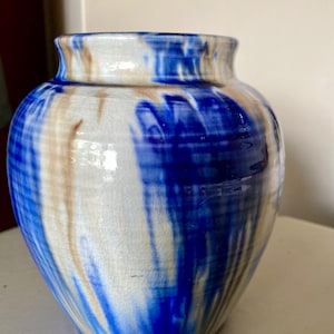 Cobalt blue and beige studio pottery pot or vase with a striking drip glaze finish