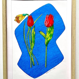 May include: A framed artwork featuring a botanical illustration of red tulips and a yellow daffodil against a blue background. The flowers have green stems and leaves. The artwork is signed and dated.