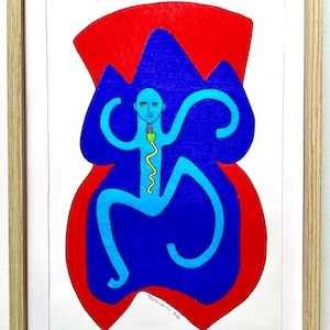 May include: Abstract art print in a wooden frame. The artwork features a blue figure with curved limbs and a yellow line, set against a red and blue background. Signed "Toma 26".