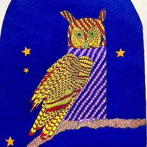 May include: A colorful illustration of an owl perched on a branch against a blue background with yellow stars. The owl features intricate patterns in red, yellow, and purple, with green eyes and a detailed design.