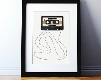 May include: A white framed print with a black and white illustration of a cassette tape. The tape is labeled "Dad's Mix Tape" and has the number 90 on it. The text around the tape is a list of song titles.