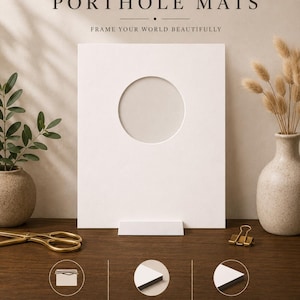 May include: A white rectangular porthole mat with a circular opening, displayed on a wooden surface. The text "PORTHOLE MATS" and "FRAME YOUR WORLD BEAUTIFULLY" are at the top. Additional text describes the mat's premium quality, acid-free nature, and beveled cut.