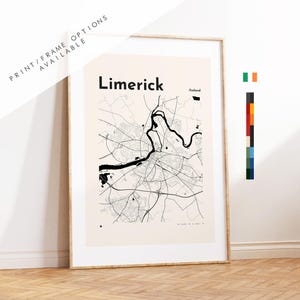 May include: A framed wall art print featuring a black and white map of Limerick, Ireland, on a light beige background. The map displays city streets and a river. The text reads Limerick and Ireland. A vertical color palette bar is on the right.