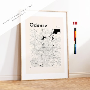 May include: Framed print of Odense, Denmark, featuring a detailed black and white map. The city name is displayed in bold black font. The print is in a light beige frame, with text at the top left corner that reads "PRINT/FRAME OPTIONS AVAILABLE".