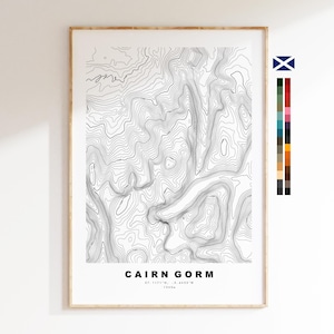 May include: A vertical framed print featuring a black and white topographic map of Cairn Gorm with contour lines. The text reads CAIRN GORM, 57.1171 N, -3.6433 W, 1245m. To the right, a small Scottish flag icon and a vertical color palette strip.