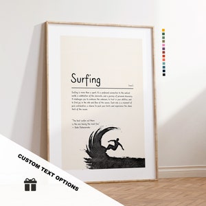 May include: A framed art print with the word "Surfing" and a definition. The image shows a black silhouette of a surfer riding a wave. The text "CUSTOM TEXT OPTIONS" is at the bottom. The print is in a wooden frame.