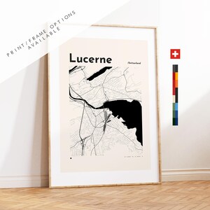 May include: Framed map print of Lucerne, Switzerland, with a beige background and black and white city details. The print includes the text "Lucerne" and "/Switzerland". The frame is a light wood color. The words "PRINT/FRAME OPTIONS AVAILABLE" are printed at the top.