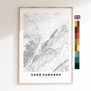 May include: A framed topographic map print of Caer Caradoc featuring black contour lines on a white background. The text at the bottom reads CAER CARADOC, 52.53392 N, -2.77378 W, 459m. A vertical color palette strip is positioned to the right of the print.