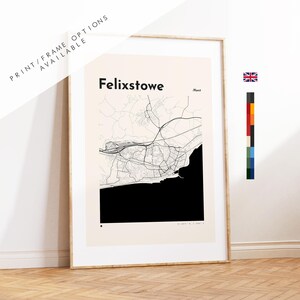 May include: A framed wall art print featuring a minimalist map of Felixstowe, England. The design displays black street lines on a cream background with a solid black area representing the coastline. The text reads Felixstowe and Kent.
