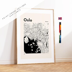 May include: A framed wall art print featuring a black and white map of Oslo, Norway. The design includes the text Oslo and /Norway in black font against a light beige background. A small Norwegian flag icon and a vertical color palette are visible.