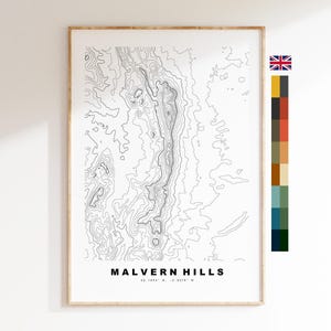 May include: A vertical poster featuring a black and white topographic map of the Malvern Hills. The print includes the text MALVERN HILLS and the coordinates 52.1094° N, -2.3378° W at the bottom. A small British flag and a vertical color palette are visible.
