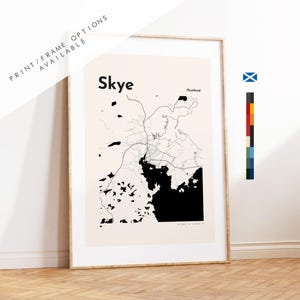 May include: A framed vertical wall art print featuring a minimalist black and white map of Skye, Scotland. The design includes the text Skye and Scotland, with black landmass shapes and thin black lines representing roads on a light beige background.