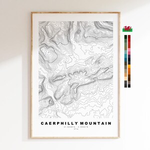 May include: A framed topographic map print of Caerphilly Mountain featuring black contour lines on a white background. The text reads CAERPHILLY MOUNTAIN, 51.56328 N, -3.22334 W, 271m. A small Welsh dragon icon and a vertical colour palette are included.