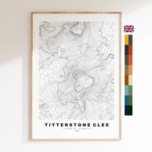 May include: A framed topographic map print of Titterstone Clee featuring black contour lines on a white background. The text reads TITTERSTONE CLEE, 52.39758 N, -2.60353 W, 533m. A vertical color palette strip is positioned to the right of the print.