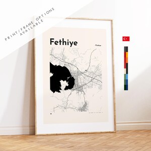 May include: Framed map print of Fethiye, Turkey, in black and white. The map features the city's layout, with the name "Fethiye" at the top. The text "Print/Frame Options Available" is also visible. A Turkish flag and color swatches are on the right.