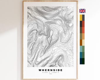 May include: A framed topographic map print of Whernside featuring black contour lines on a white background. The text reads Whernside, 54.2274° N, 2.4033° W, and 736m. A vertical colour palette strip is positioned to the right of the map.