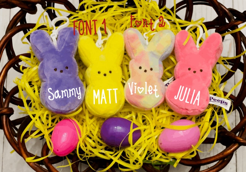 May include: Four plush Peep bunny toys in a basket with yellow shredded paper. The bunnies are purple, yellow, tie-dye, and pink. Each bunny has a name on it: Sammy, Matt, Violet, and Julia.