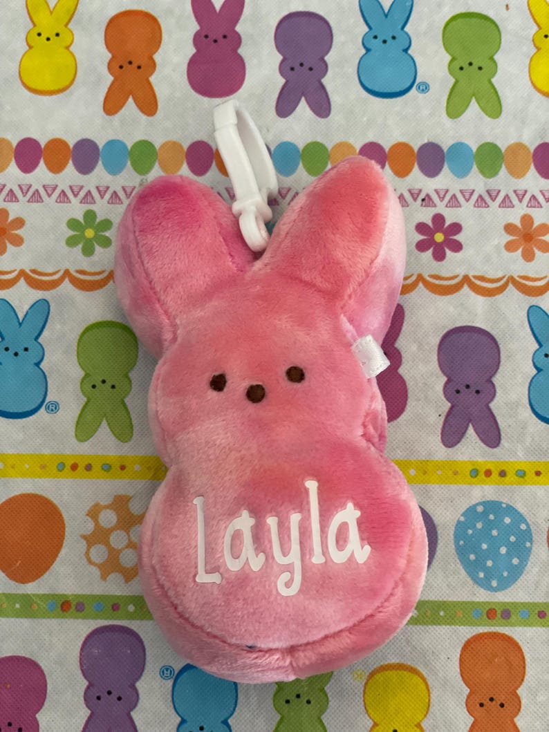 May include: Pink plush Peeps bunny with a white clip and the name "Layla" embroidered on the front.