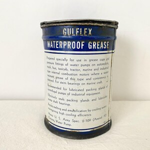 May include: A vintage Gulflex Waterproof Grease tin, featuring a blue and white label. The label provides information on its use in grease cups, water pumps, and marine applications.