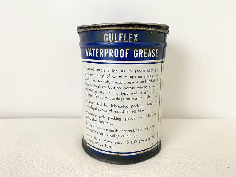 May include: A vintage Gulflex Waterproof Grease tin, featuring a blue and white label. The label provides information on its use in grease cups, water pumps, and marine applications.