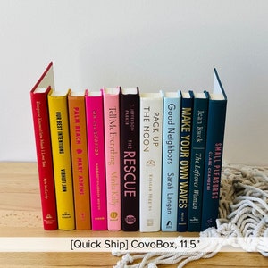 May include: A bookshelf with 11 books, all different colors and sizes. The books are arranged in a row, with the spines facing out. The titles of the books are visible, including "Our Best Intentions", "Palm Beach", "Tell Me Everything", "The Rescue", "Pack Up", "Good Neighbors", "Make Your Own Waves", "The Leftover Woman", and "Small Pleasures".