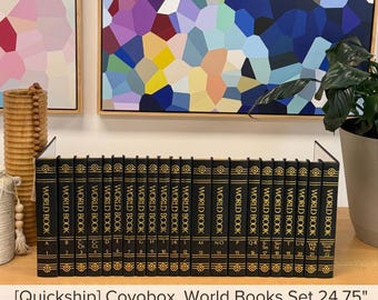 May include: A complete set of twenty-two black World Book encyclopedia volumes arranged in a row. Each spine features gold lettering and decorative borders, with volume numbers 1 through 22 and corresponding letters clearly printed on the front.