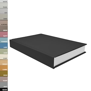 May include: A rectangular black book with white pages, positioned at an angle. To the left, a vertical color palette strip displays labels including White, Pearl, Ash, Sand, Almond, Beige, Taffy, Powder, Lake, Sage, Ivory, Wheat, Camel, Gold, Taupe, Gray, Black.