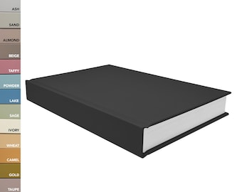 May include: A rectangular black book with white pages, positioned at an angle. To the left, a vertical color palette strip displays labels including White, Pearl, Ash, Sand, Almond, Beige, Taffy, Powder, Lake, Sage, Ivory, Wheat, Camel, Gold, Taupe, Gray, Black.