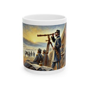 May include: White ceramic mug featuring a detailed illustration of a Civil War scene. A man in a blue uniform uses a telescope, with other soldiers and a cannon in the background. The artwork is set against a sunset backdrop.