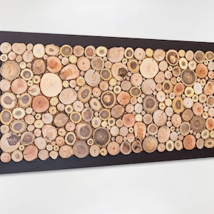 Side image. This is a beautiful and elegant decorative and fine art made from slices of tree branches of different shades. The slices take up almost the entire surface and the 2 in exterior is painted dark brown. Size: 48 x 24 in. Can be personalised