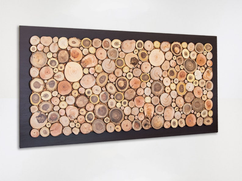 Side image. This is a beautiful and elegant decorative and fine art made from slices of tree branches of different shades. The slices take up almost the entire surface and the 2 in exterior is painted dark brown. Size: 48 x 24 in. Can be personalised