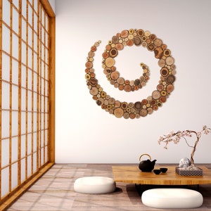 It is an artwork in the shape of a spiral placed on the wall in a zen environment. The spiral is made from slices of tree branches and has great beauty and personality due to the shape and shades of the slices. Sizes: 20, 24, 28, 32, 36, 40 in.