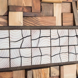 The image shows a detail of the central part. It is a very original mosaic of pieces of wood that are different from the rest of the work and are cut in half. The wood grain and the warm tones can be appreciated. Dimensions: 48 x 24 in.