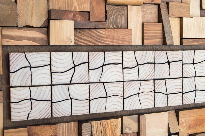 The image shows a detail of the central part. It is a very original mosaic of pieces of wood that are different from the rest of the work and are cut in half. The wood grain and the warm tones can be appreciated. Dimensions: 48 x 24 in.