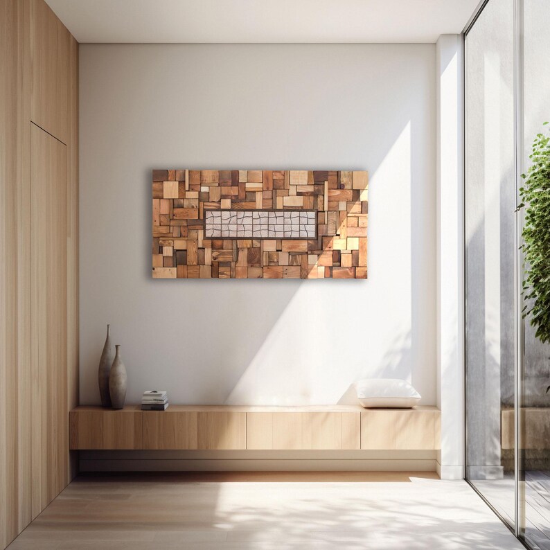 May include: A rectangular wooden wall art piece composed of various sized wood blocks in shades of brown and tan. A rectangular section in the center features a mosaic-like pattern. The artwork hangs on a white wall above a wooden cabinet.