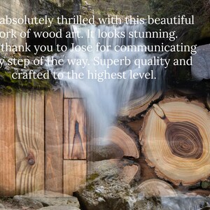 May include: A close-up of a wooden art piece with a natural wood grain pattern. The wood is a light brown color with darker brown streaks. The wood is arranged in a pattern of overlapping pieces, creating a unique and interesting design. The wood is surrounded by a blurred background of a waterfall and rocks.